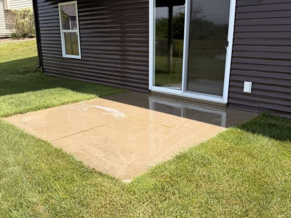 Dirty, streaked concrete patio before pressure washing