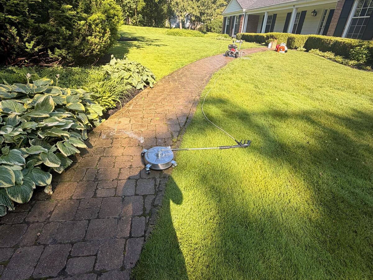 Paver walkway being pressure washed with a surface cleaner