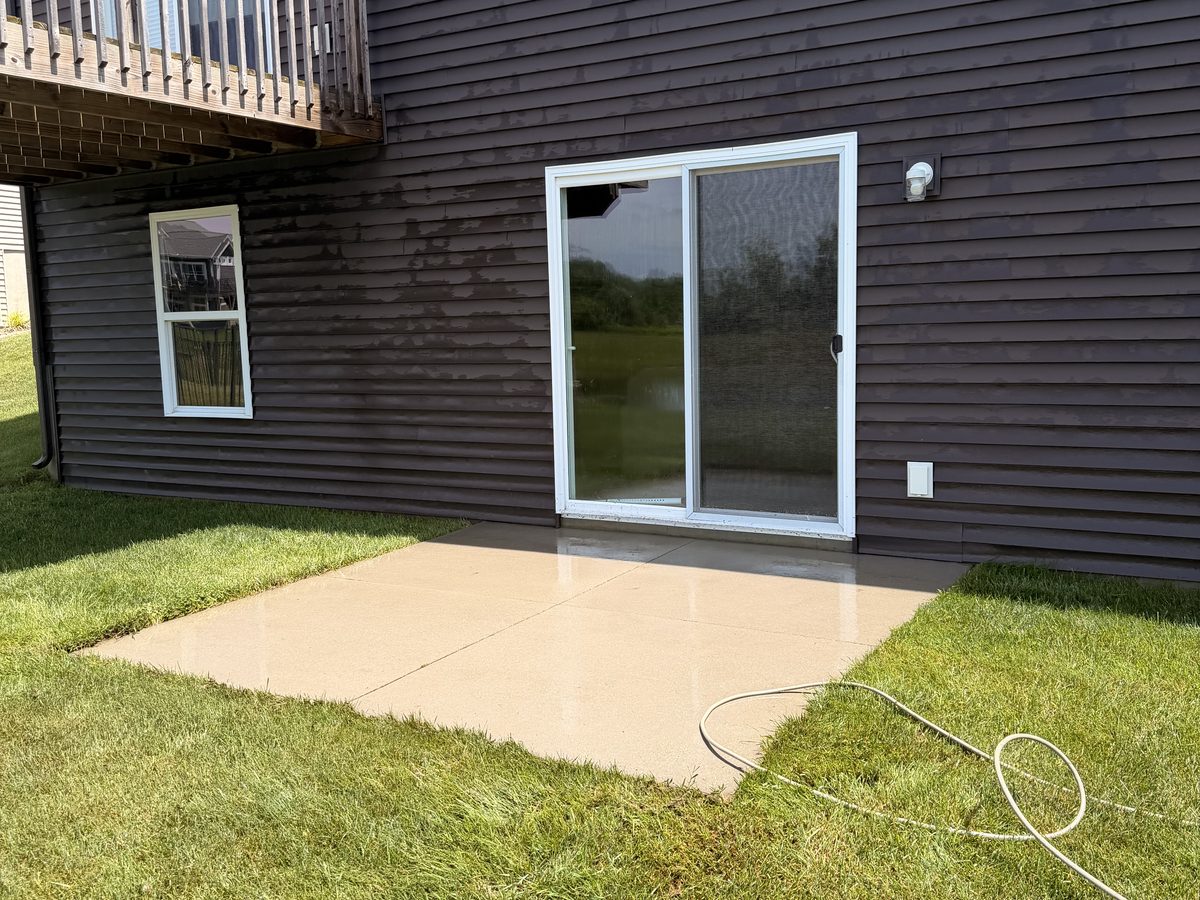 Bright, clean concrete patio after pressure washing